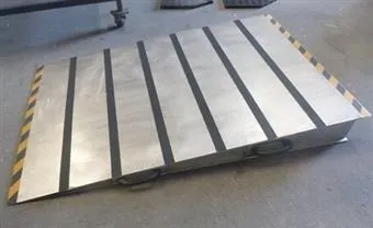 A silver coloured portable ramp