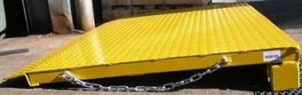 A yellow ramp infill piece with safety chain & hook