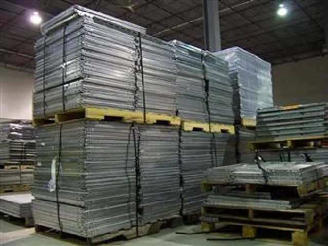 Pallets of light grey and silver coloured Second Hand Metal Shelving.