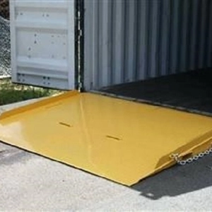 Yellow coloured Forklift Container Ramp sitting at the end of an open shipping container.